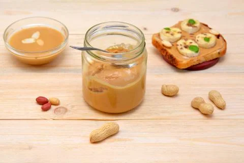 Open jar of peanut butter for making toast Stock Photos