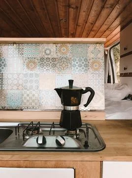Open kitchen in a camping van - cooking coffee in the open air - vanlife Stock Photos