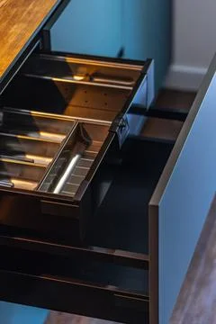 Open kitchen drawer with metal inserts. Modern cabinet storage and interior.. Stock Photos