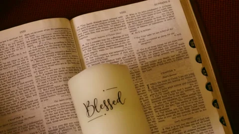 Open KJV bible with the word BLESSED lying on top Stock Footage 153577182