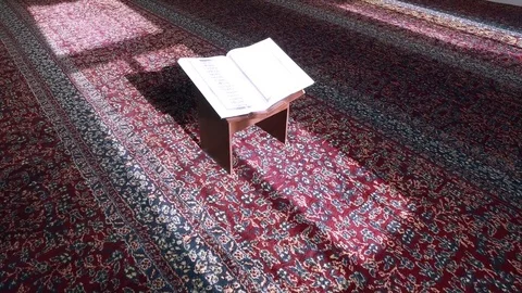 Open the Koran in the Mosque on the Table. Are visible Ayyats. Stock Footage 76246471