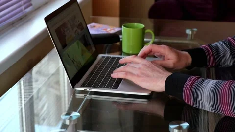 Open laptop, big cup of coffee on a glass table in the morning in the kitch.. Stock Footage 237384911