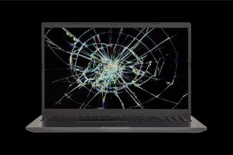 An open laptop with a broken screen Isolated on a black background close-up f Stock Photos