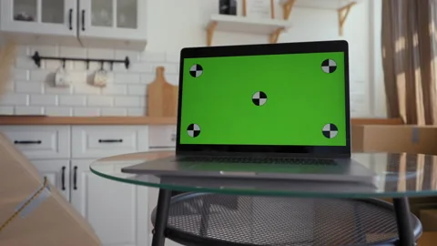 Open laptop with chromakey screen stands on glass table Vidéo 201186877