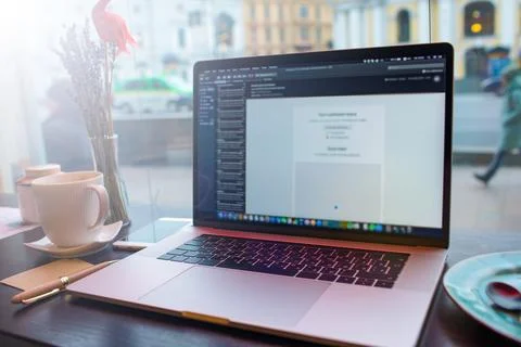 Open laptop computer with blurred programs on the screen lying on wooden tabl Foto stock