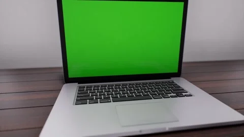 An open laptop computer sitting on top of a wooden table Stock Footage 155219823