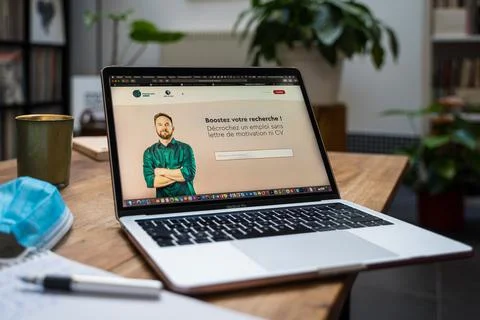 An open laptop computer sitting on top of a table Stock Photos