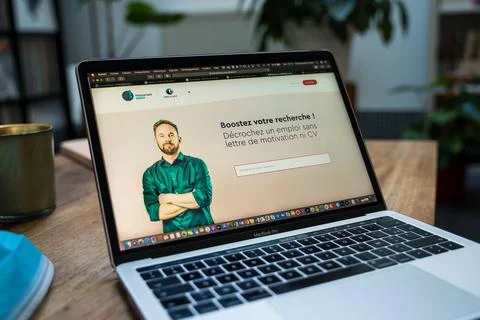An open laptop computer sitting on top of a table Stock Photos