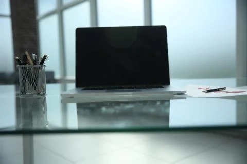 Open laptop on Desk in empty office Stock Photos