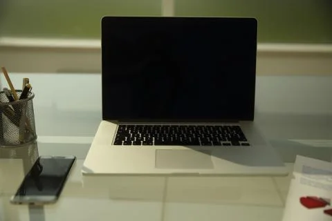 Open laptop on Desk in empty office Stock Photos
