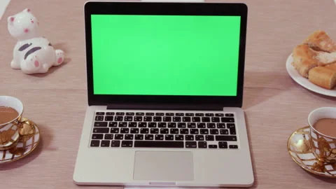 Open laptop with green chromakey screen on wooden table Stock Footage 229844272