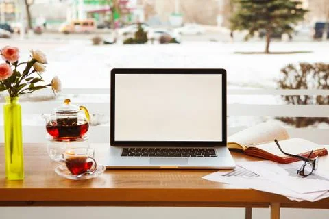 Open laptop, scribbling-book, graphics, glasses lying on desktop Foto stock