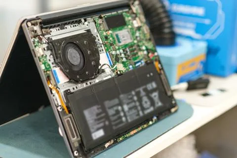Open laptop showing internal components including motherboard, fan, and battery Stock Photos