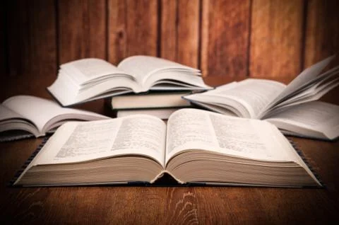Open large book on a wood table Stock Photos