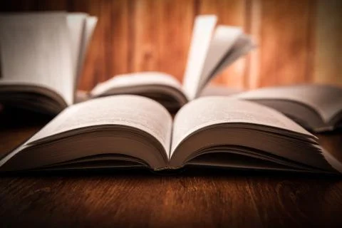 Open large book on a wood table Stock Photos
