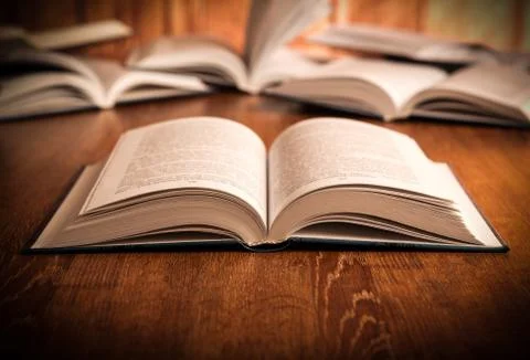 Open large book on a wood table Stock Photos