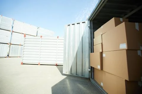 Open large container with stack of boxes 스톡 사진