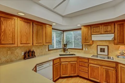 Open large kitchen interior with vaulted ceiling and white appliances from ni Stock Photos