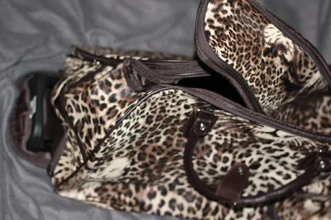 Open Leopard Print Rolling Travel Bag with Handles Stock Photos