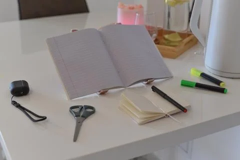 Open lined notebook on stand on white table with stationery for study Foto stock