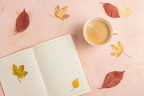 Open lined notepad, coffee and yellow fall leaves Stock Photos