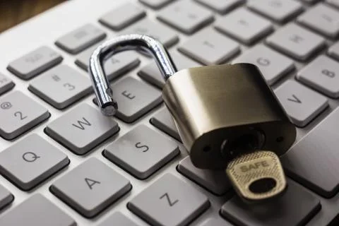 Open lock with word SAFE on key on keyboard. Stock Photos