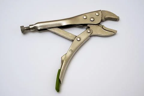 Open locking pliers on a white background. Artisan's hand tool close-up Stock Photos