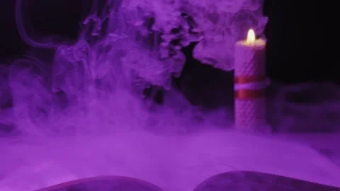 Open Magic Book And Candle Surrounded By Swirling Mysterious Purple Smoke Stock Footage 330401894
