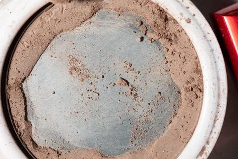 Open makeup compact with worn pan and crumbling powder - real-world wear cues Stock Photos