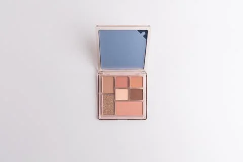 Open makeup eyeshadow palette with mirror isolated on a pure white background Stock Photos