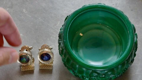 Open malachite casket and taking golden cufflinks Stock Footage 95949075