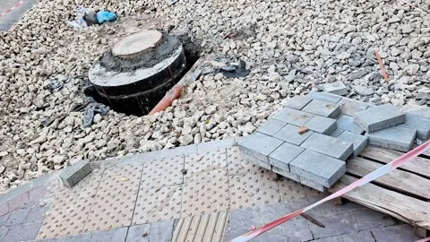 Open Manhole During Sidewalk Paving and Urban Construction Work Stock Footage 339134154