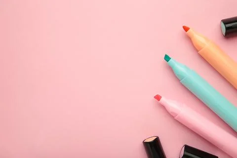 Open markers and space for text on pink background. Stock Photos