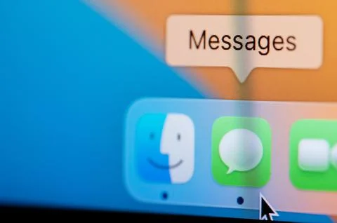 Open Messages app in macbook dock Stock Photos