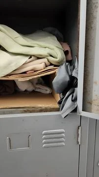 Open Metal Locker with Folded Clothes and Fabric Storage Stock Photos