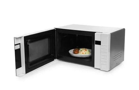 Open microwave oven with cooked rice and chicken isolated on white Stock Photos