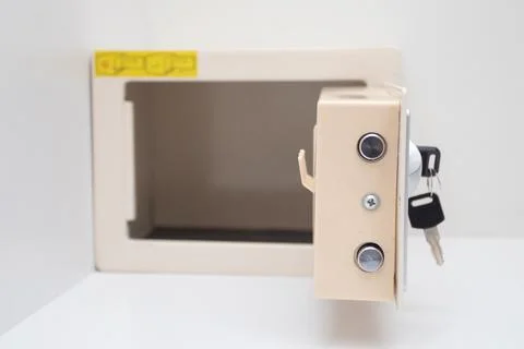 Open mini safe box with keys on white background Foto stock