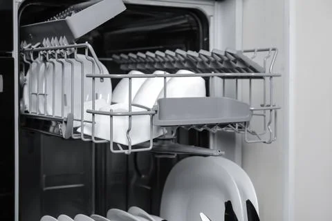 Open modern dishwasher with clean tableware, closeup Stock Photos