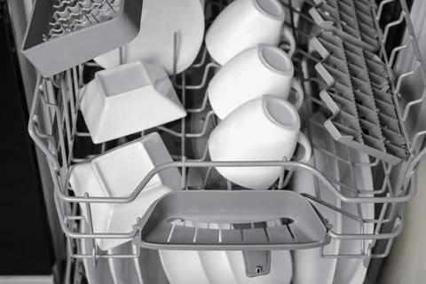 Open modern dishwasher with clean tableware, closeup Stock Photos