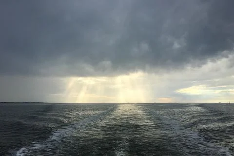 Open North Sea with Dramatic Sky after a Rain Storm. Dark Clouds and Rays of Stock Photos