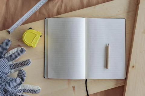 Open note book with blank pages in carpentry workshop Stock Photos