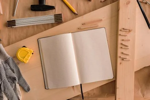 Open note book with blank pages in carpentry workshop Stock Photos