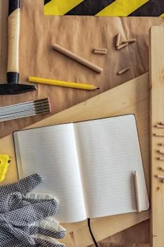 Open note book with blank pages in carpentry workshop Stock Photos