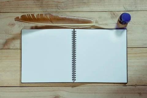 Open note book with feather pen,filter effect. Stock Photos