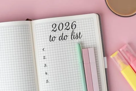 Open notebook with 2026 to do list written on graph paper, surrounded by pa.. Stock Photos