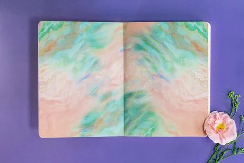 Open Notebook with Abstract Pastel Pages and Pink Flower Stock Photos