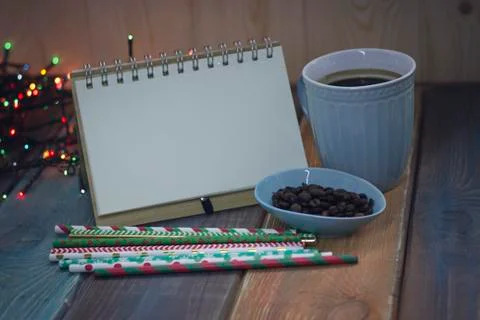 Open notebook and a cup of coffee on the table Stock Photos