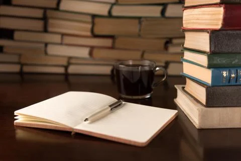 Open notebook and cup  on the desktop Stock Photos