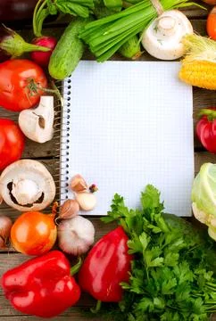 Open Notebook and Fresh Vegetables Background. Diet Stock Photos