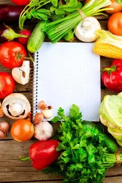 Open Notebook and Fresh Vegetables Background. Diet Stock Photos